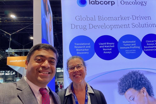 Our employees, Mary and Vivek, taking a selfie at the Labcorp booth