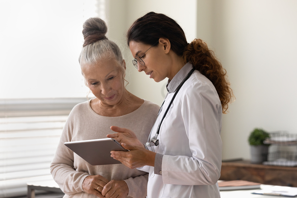 Provider showing a tablet to a patient